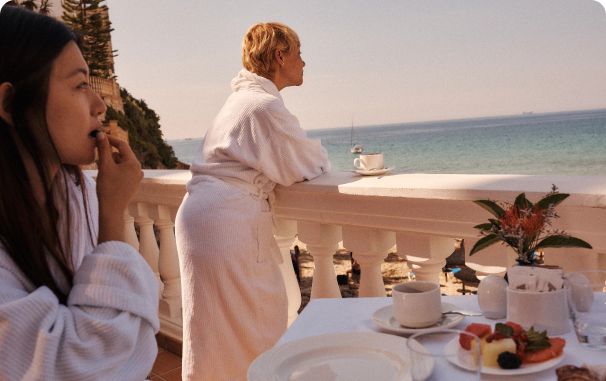 Two women looking at a ocean vista while at a spa